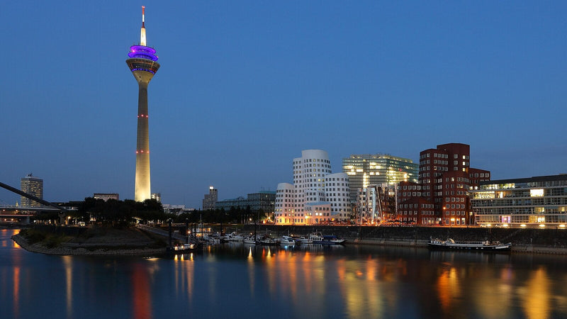 The Rheinturm and the Neuer Zollhof in Düsseldorf's Medienhafen at blue hour